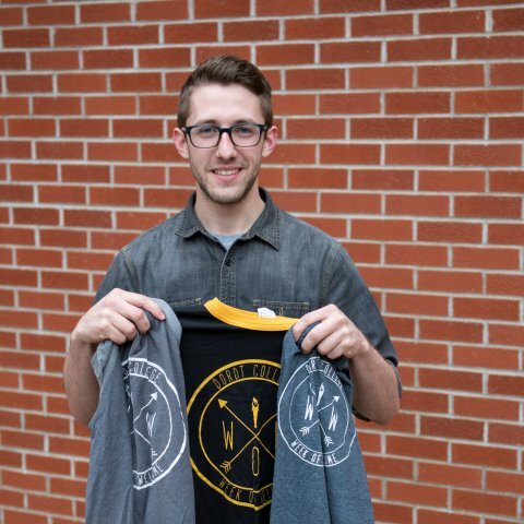 A picture of Daniel Seaman holding a week of welcome jacket