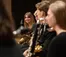 A musician smiles at fellow musicians