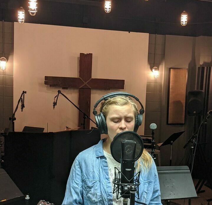 female student sings recording in the worship arts studio