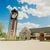 A picture of Dordt's clocktower and campus center on a sunny day with big white clouds in the background.
