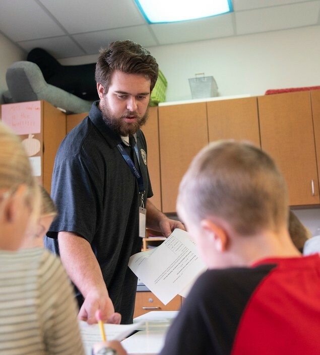 A picture of a teacher handing out homework