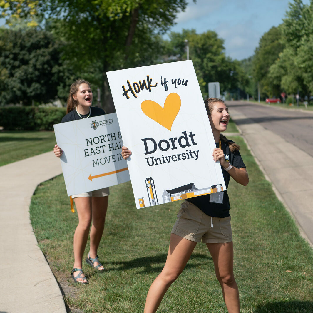 Dordt students hold up "Honk if you love Dordt" signs