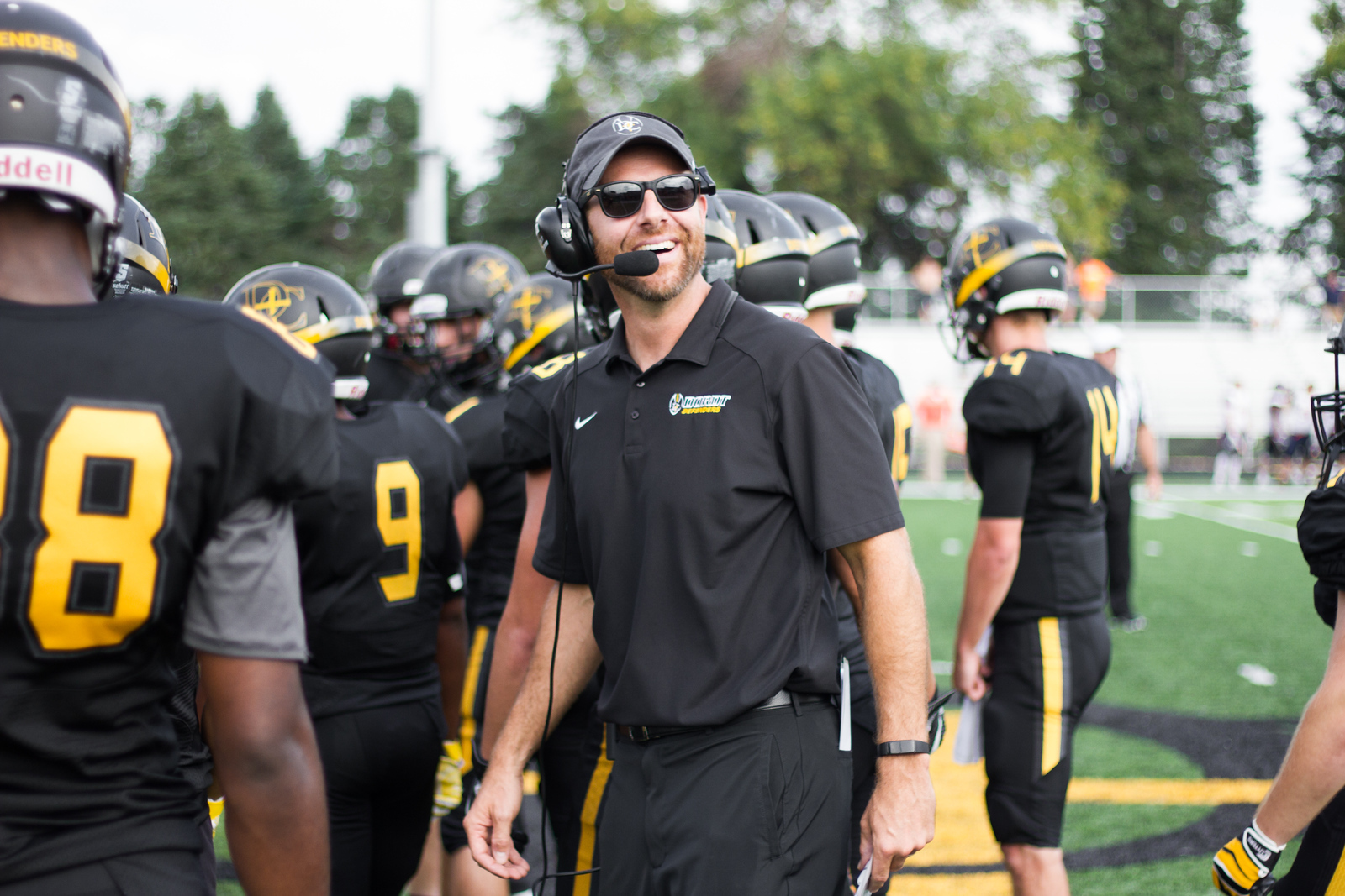 The Dordt football coach look back from the team huddle