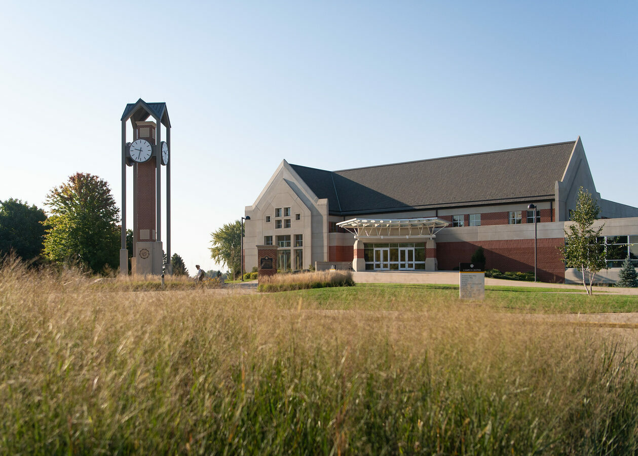 A picture of prairie grass with Dordt's campus in the background.