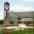 A picture of Dordt's campus with some red and yellow prairie flowers in front of it.