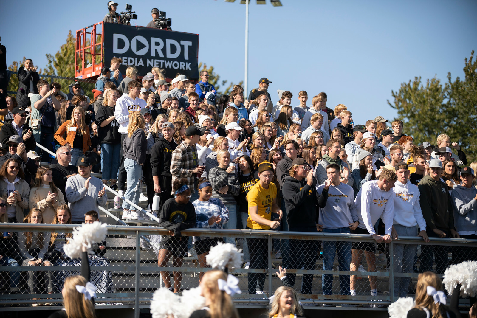 A picture of students cheering during a football game