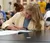 A student taking notes while sitting in a lab.