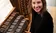 headshot of woman sitting at piano