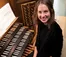 headshot of woman sitting at piano