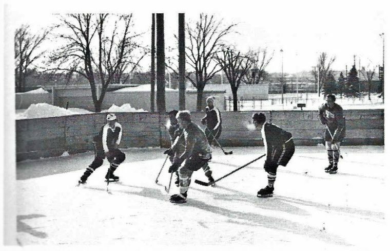 A group of men play ice hockey