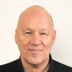 Smiling bald man in black polo