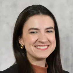 Smiling young lady with straight dark hair
