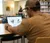 A student studies an diagram of a skull on his laptop