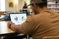 A student studies an diagram of a skull on his laptop