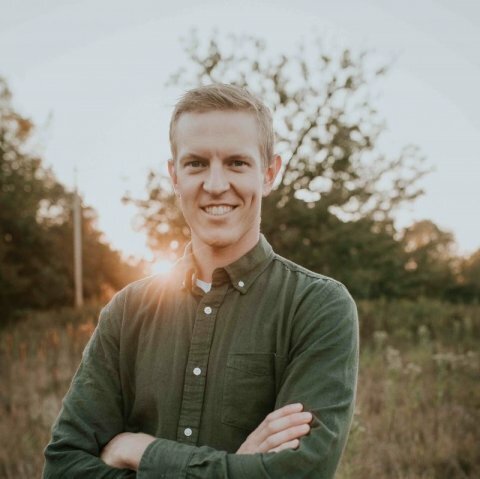 A picture of a man with a green shirt standing in Dordt's prairie