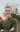 A picture of a man with a green shirt standing in Dordt's prairie